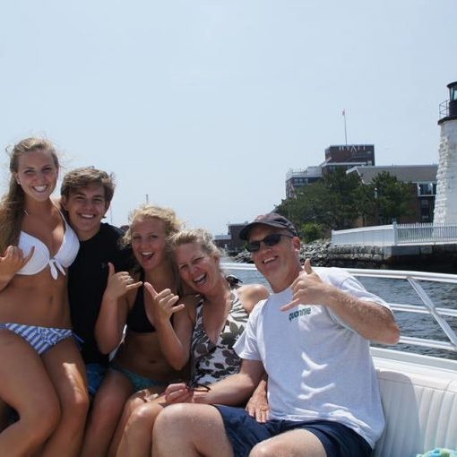 a group of people sitting at a dock