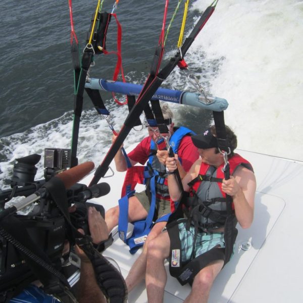 a group of people riding on the back of a boat