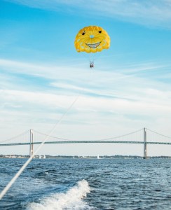 a person flying a kite in a large body of water